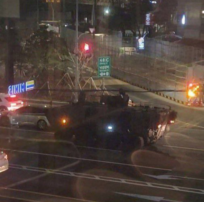Military vehicle at night in South Korea after martial law declaration was rejected by parliament.