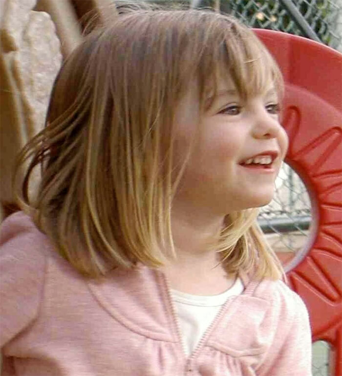 Young girl smiling outdoors with playground equipment in the background, related to Madeleine McCann story.