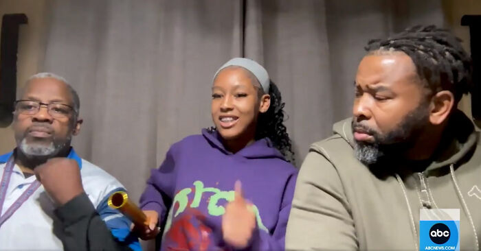 Young woman in purple hoodie shares video to support innocence, flanked by two men, in a news interview setting.