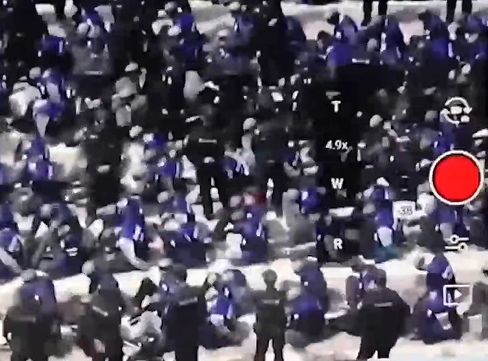 Large group of people gathered, viewed through a digital camera screen, related to Chinese-Canadian insights on China.