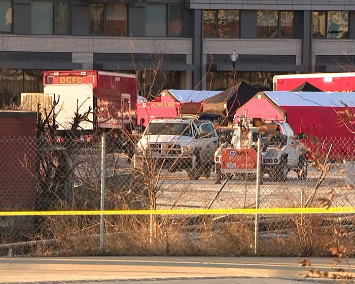 Emergency vehicles and tents at the scene of a DC American Airlines plane crash.