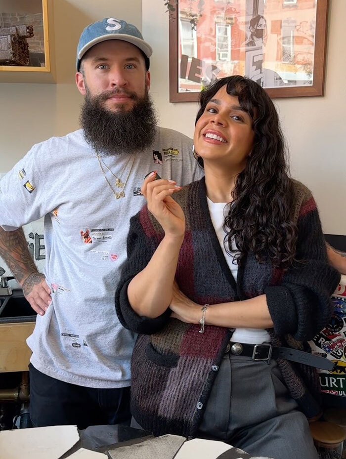 NYC cafe attracts thousands; visitors pose cheerfully inside.