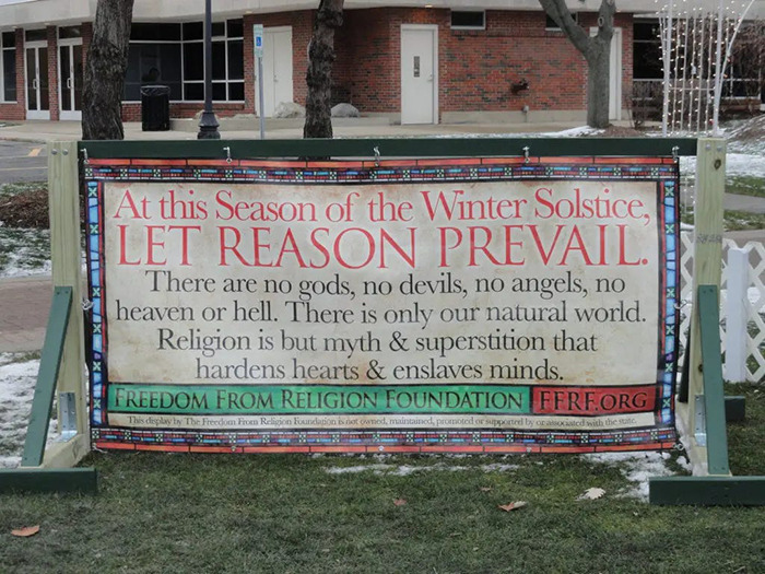 Billboard by atheist group advocating reason during Christmas, part of holiday message exchange with Christian groups.