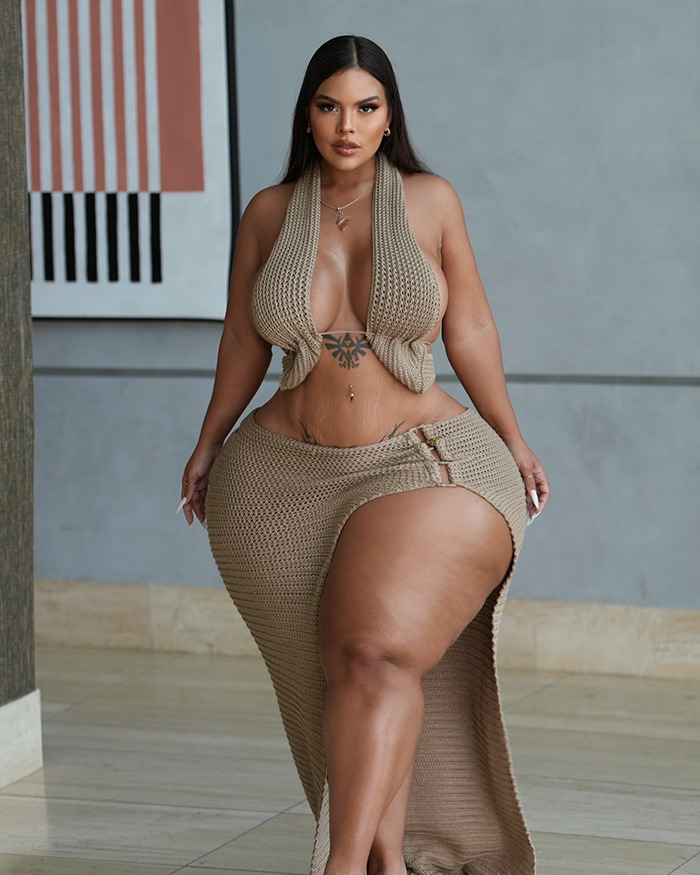 Plus-size influencer posing confidently in a stylish beige outfit.