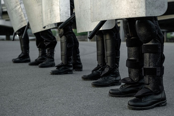 Riot police in formation with shields during martial law in South Korea.