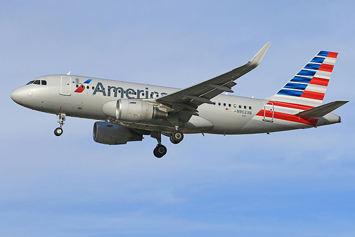 American Airlines plane in flight against a blue sky, referenced in DC plane crash story.