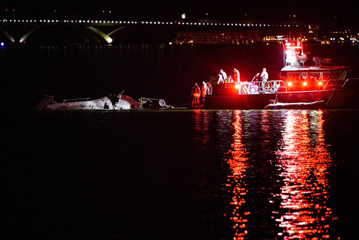 Rescue boats near crash site at night following Black Hawk drill in DC waters.