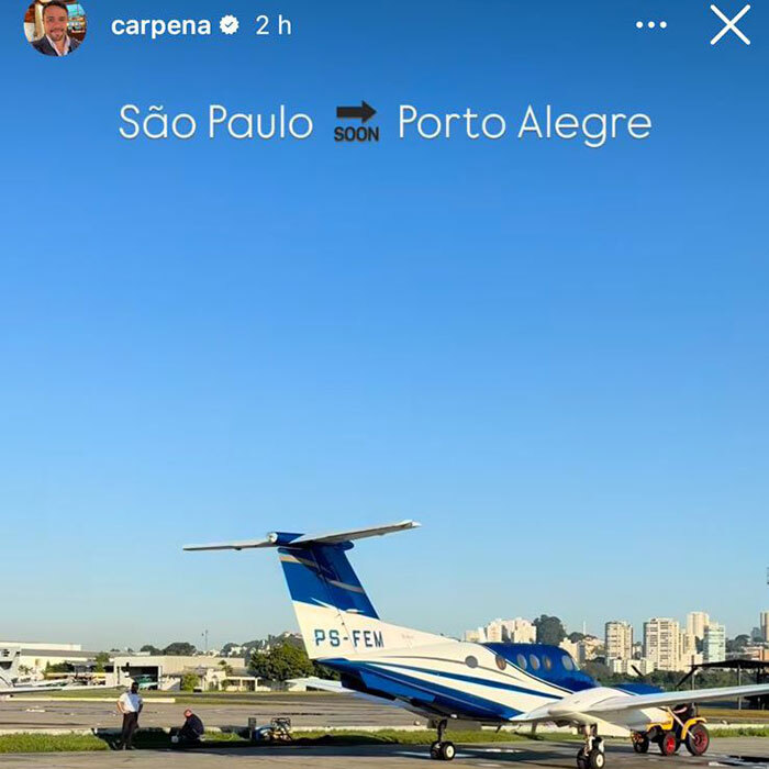 Plane waits on runway in S&atilde;o Paulo with city skyline, related to latest aviation disaster.