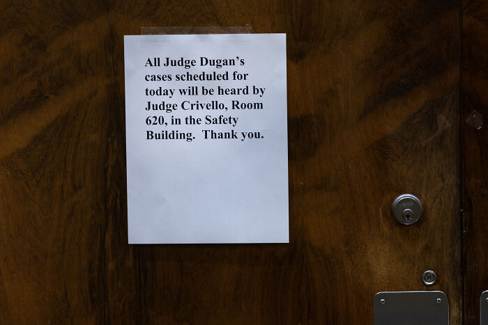 Sign on courthouse door about judge cases, related to judge suspended for helping defendant evade ICE agents.
