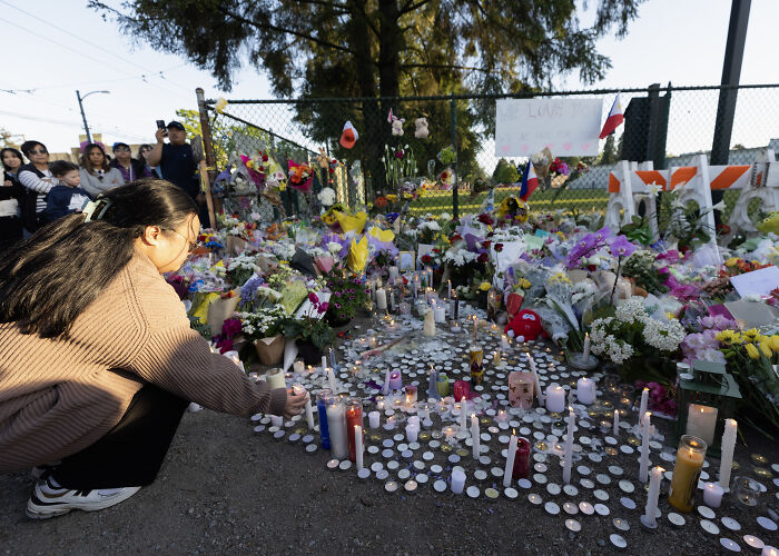 Vigil for victims of Vancouver festival car-ramming massacre with flowers and candles.
