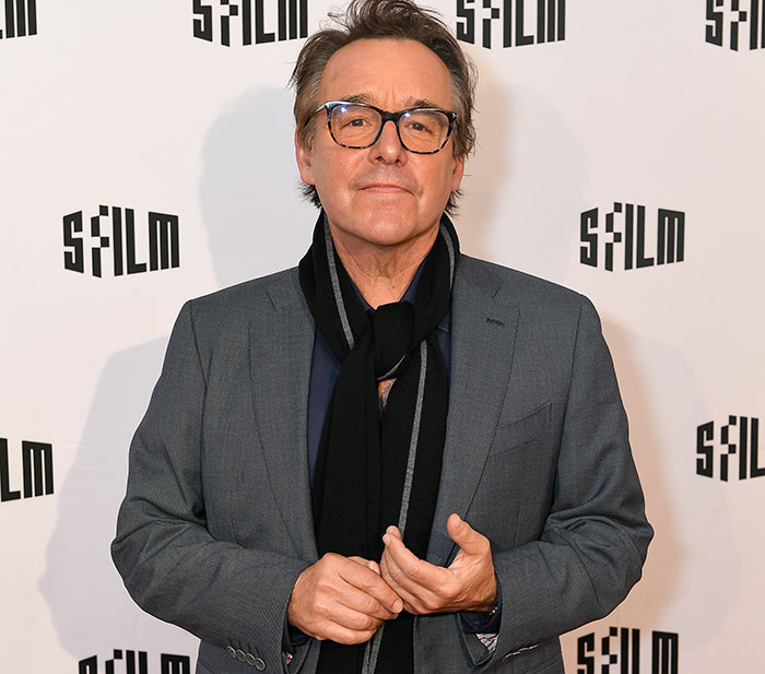 Director of 'Home Alone 2' at SF Film event, wearing a scarf and glasses, discussing Trump cameo concerns.