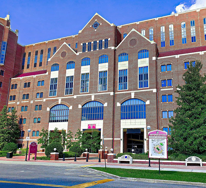 FSU campus building exterior with brick facade and arched windows on a sunny day.