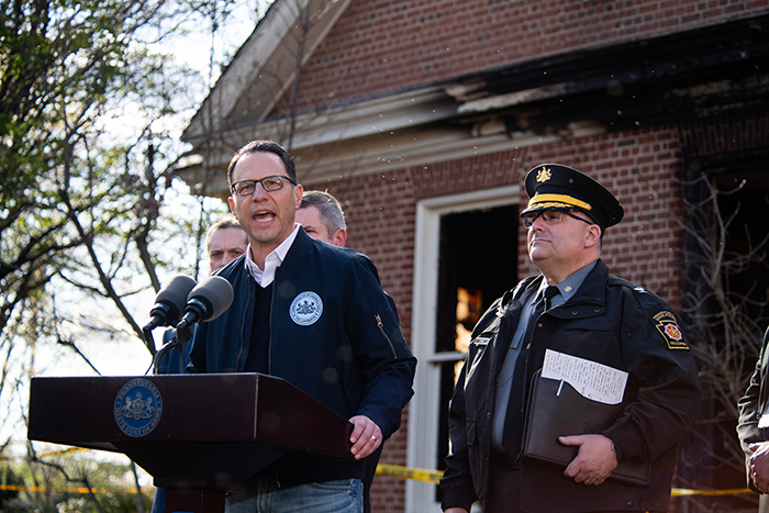 A man addresses media after PA Governor's house fire, following arson charge revelation.