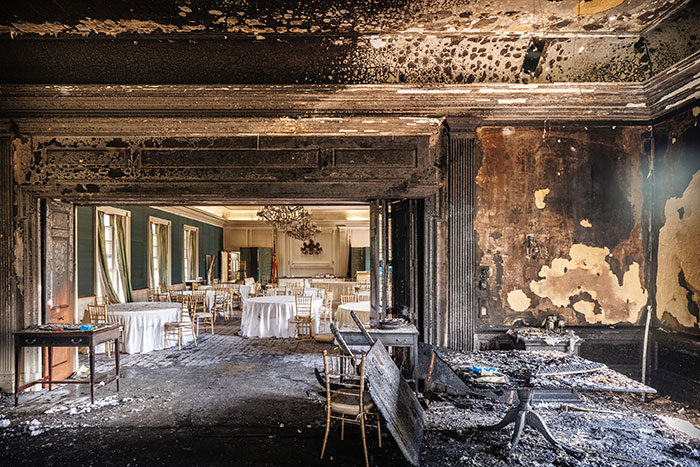 Burned interior of a room with chairs and tables, related to Cody Balmer incident at PA Governor's residence.