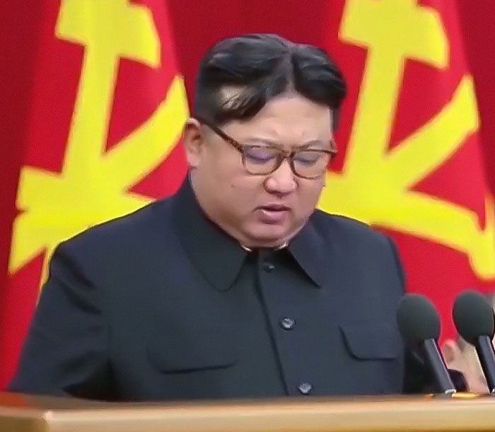 North Korean leader speaking at podium, addressing troop deployment in Ukraine conflict.