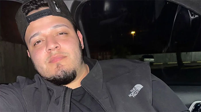 A person in a dark jacket inside a car, related to El Salvador visit denial involving Kilmar Abrego Garcia.