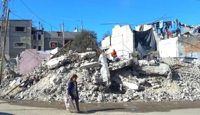 Child walks past rubble in Gaza as Pope Francis&rsquo; Popemobile is set to be converted into a mobile health unit for Gaza children