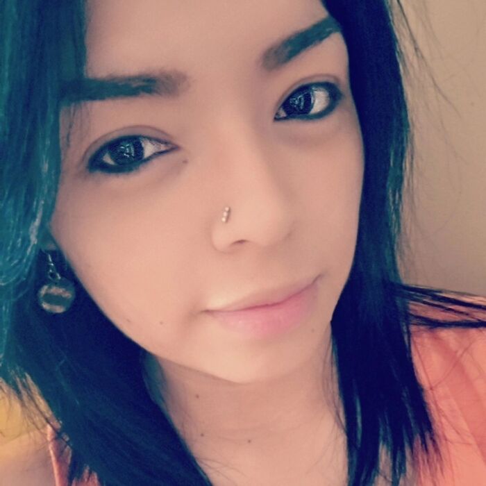 Close-up of a woman with dark hair and a nose piercing, related to dad faces new charge after allegedly shooting son.