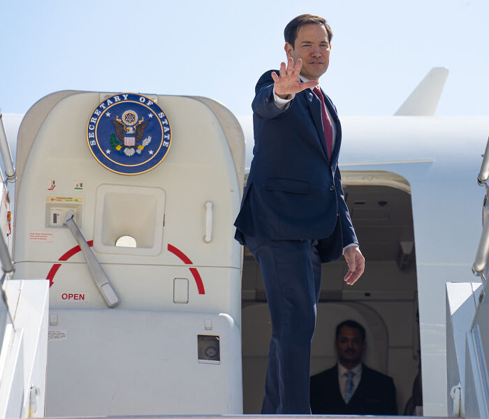 U.S. official boarding plane as student visa freeze begins amid social media profile checks.