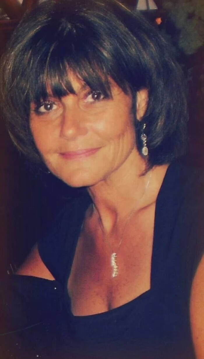 Portrait of a woman with short hair wearing a black dress and jewelry, related to divorce lawyer charged case.