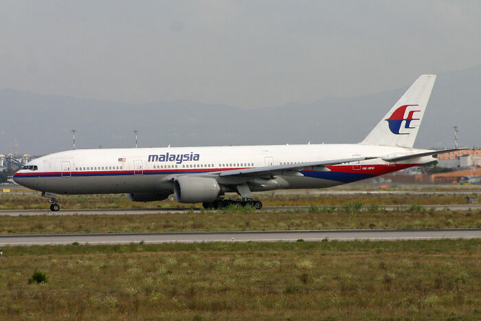 Malaysia Airlines plane on runway, related to Russia liable ruling by UN aviation agency for MH17 downing in 2014.