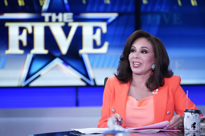 Fox News host in an orange blazer on the set of The Five, relating to Trump picks for top D.C. post discussion.