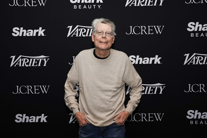 Stephen King at a Variety event wearing glasses and a beige sweater, addressing backlash over a racist Trump joke.