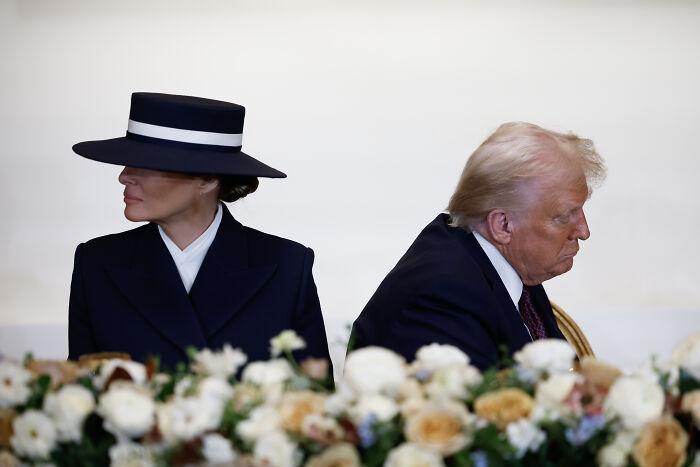 Donald Trump and Melania Trump seated back-to-back, highlighting their separated relationship and unique marriage norms.