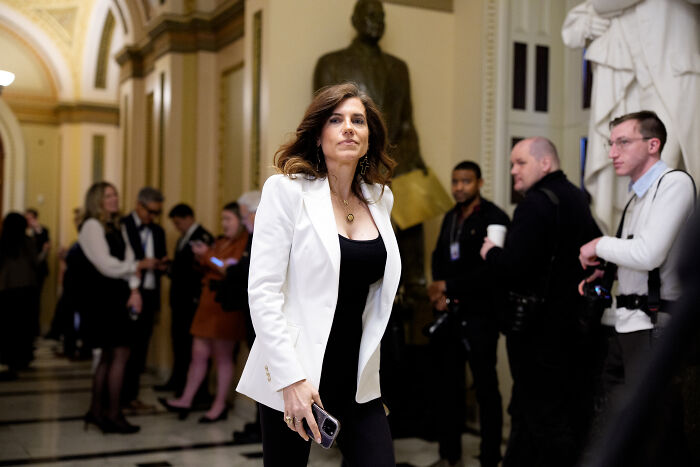 Nancy Mace walking in a hallway during a House hearing where she showed a controversial naked image of herself.