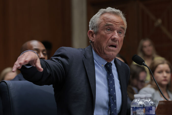 RFK Jr. speaking passionately at a hearing, emphasizing Americans should not take medical advice from him.