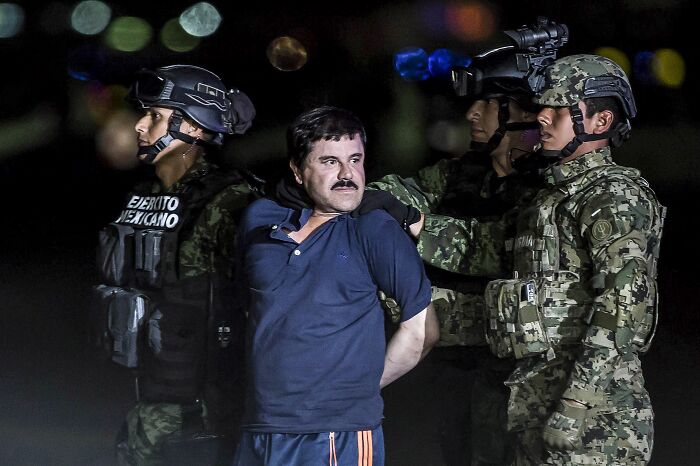 Mexican cartel family members detained by military personnel at night amid U.S. security operations under Trump administration.