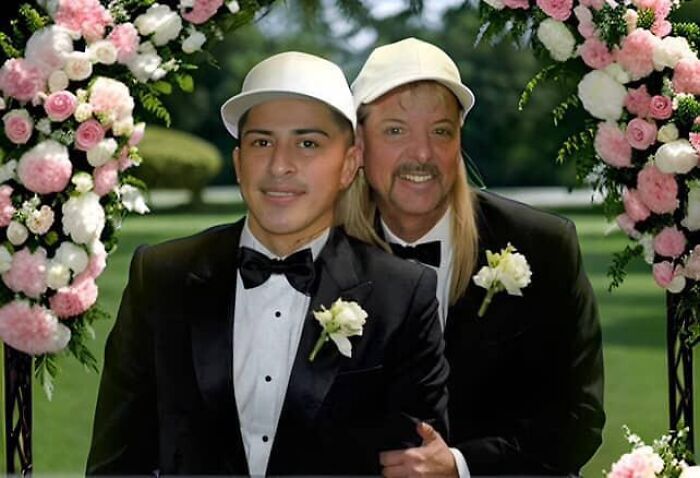 Joe Exotic&rsquo;s husband and partner wearing tuxedos and hats at an outdoor wedding under floral arch decorations.