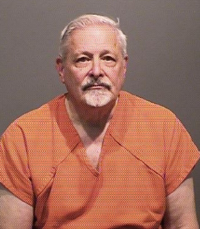 Mugshot of an older man in an orange prison uniform related to orphanage abuse and sentencing news.