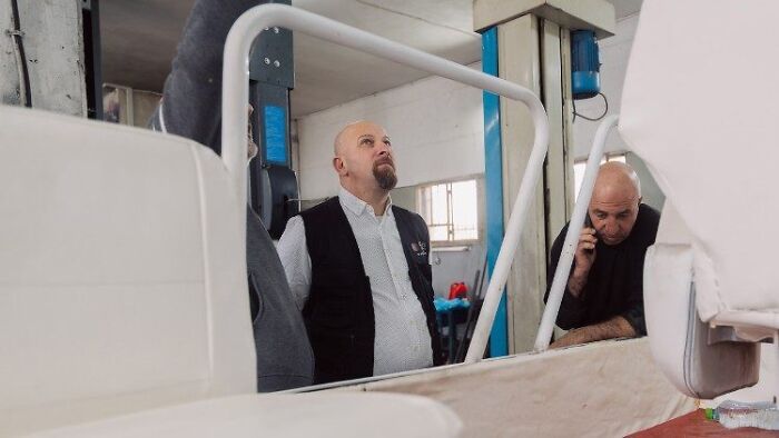 Technicians inspecting the interior of Pope Francis&rsquo; Popemobile being converted into a mobile health unit for Gaza children.