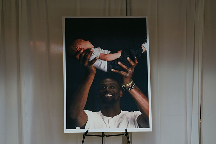 Photo showing a smiling man holding a baby, related to Memphis police officers found not guilty in Tyre Nichols case.