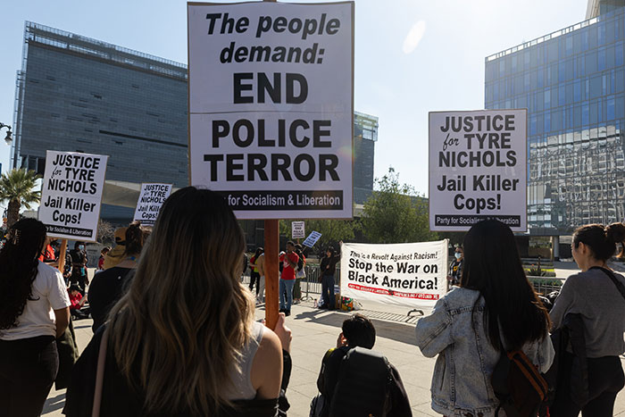 Protesters holding signs demanding justice for Tyre Nichols and calling to end police terror in Memphis city center.
