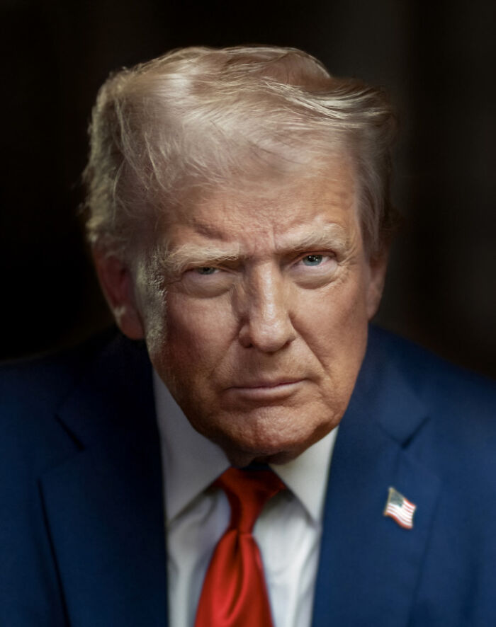 Close-up portrait of Donald Trump in a blue suit with red tie, representing the White House Trump portrait unveiling.