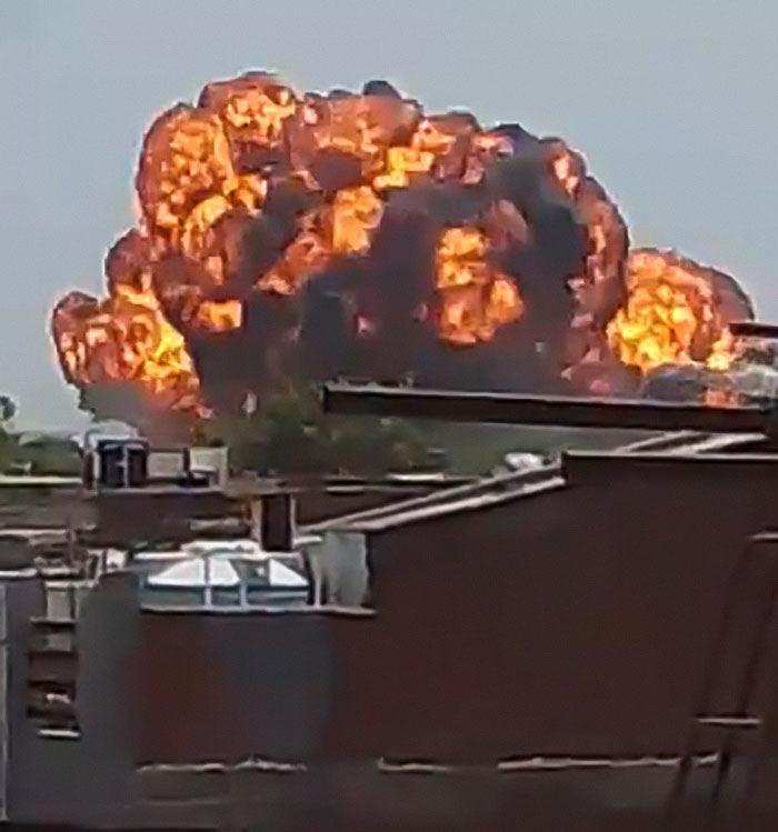 Massive fiery explosion in the sky captured near buildings, related to Air India crash lone survivor miracle moments.