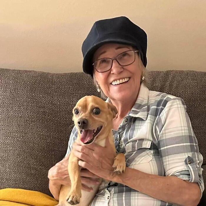 Elderly woman smiling and holding a small dog, related to Trump pardon proposal to Jan 6 rioter MAGA Granny.