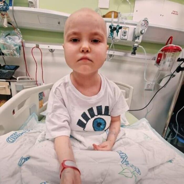Seven-year-old girl with cancer receiving treatment in hospital bed, affected by Ukraine war and missile strike in Iran.