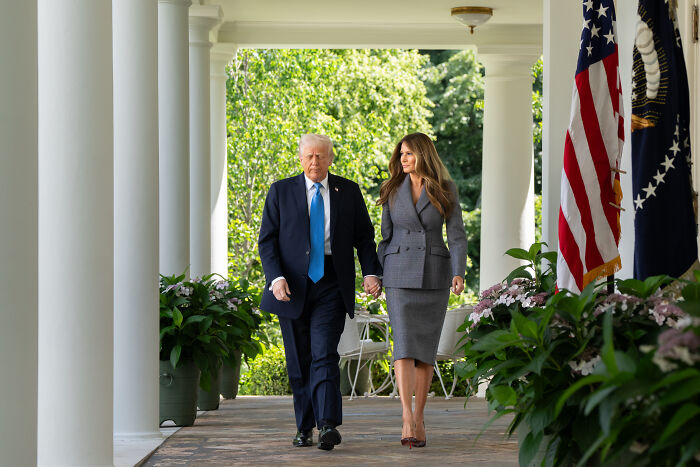 Donald Trump and Melania Trump walking in the White House Rose Garden after paving started five years post makeover.