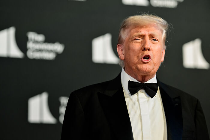 Donald Trump in a tuxedo speaking at a formal event, related to judge orders on NIH grants reinstatement.