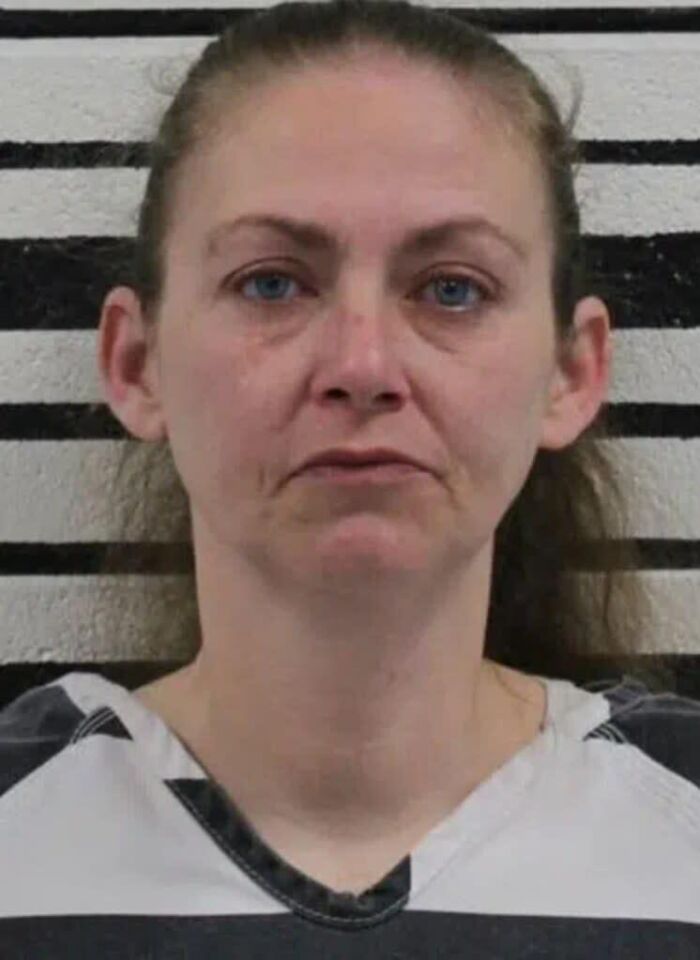 Mugshot of a woman wearing a striped shirt, related to foster parents charged with killing 3-year-old girl with autism.