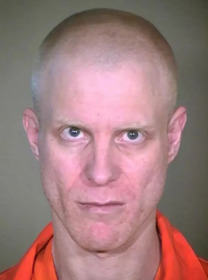 Mugshot of a bald man in an orange prison uniform linked to killer dad who set his kid on fire case.
