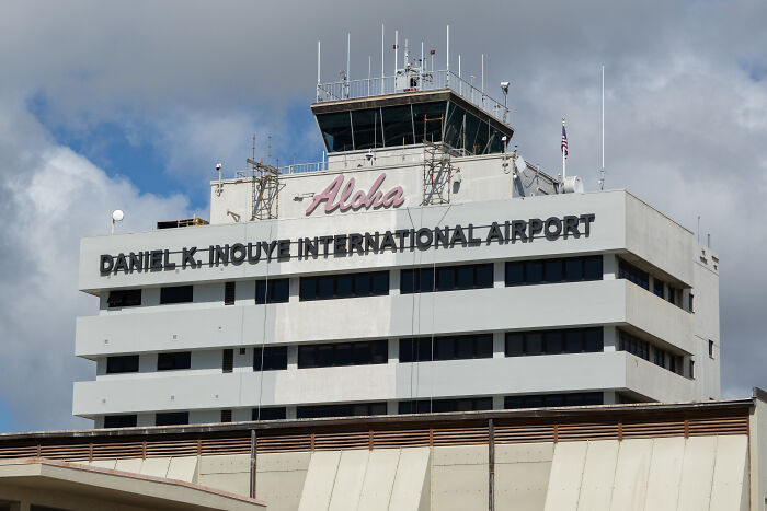 Control tower and signage at Daniel K Inouye International Airport amid DHS response after agents jailed and deported Aussie bride