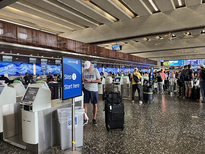 Airport check-in area showing passengers with luggage, highlighting DHS response after agents jailed and deported Aussie bride.