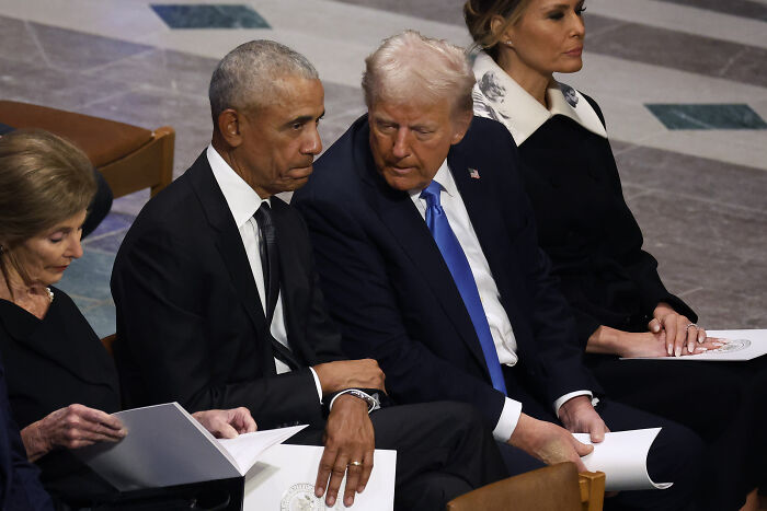 Barack Obama and Donald Trump seated closely together during a formal event, highlighting political tension and MAGA hypocrisy.