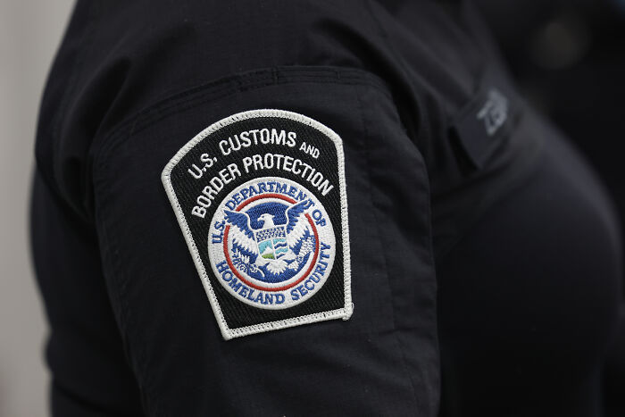 Close-up of a U.S. Customs and Border Protection patch on a uniform related to DHS response after Aussie bride deportation.