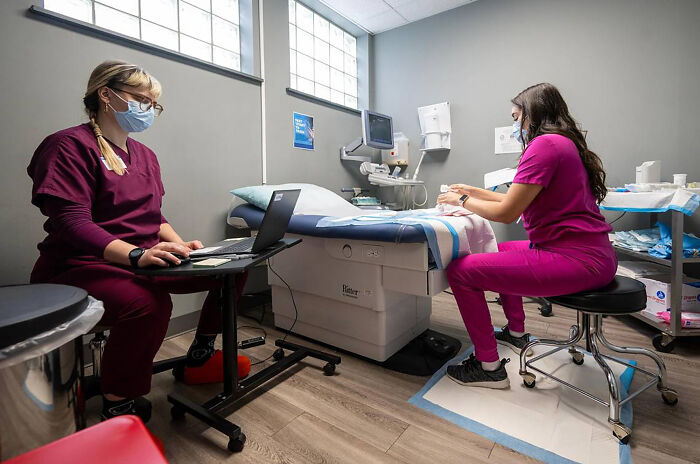 Two healthcare workers in a clinic setting, highlighting South Carolina Medicaid fund cuts to Planned Parenthood.