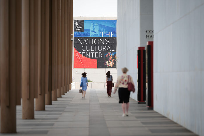People walking toward a building with a banner reading Nation&rsquo;s Cultural Center on Donald and Melania Trump Les Mis&eacute;rables event